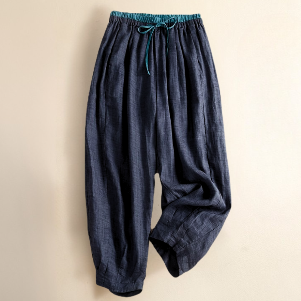 Light beige tapered linen trousers for women by Christine Brewer, featuring a loose pull-on style and relaxed fit.