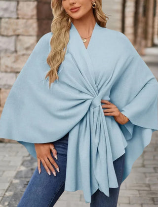 Christine Brewer Cecilia knit poncho for women, stylish and cozy top in soft fabric, draped over a model's shoulders.