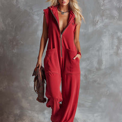 Raspberry red cotton hooded zip-front jumpsuit for women, featuring long sleeves and a relaxed fit by Christine Brewer.