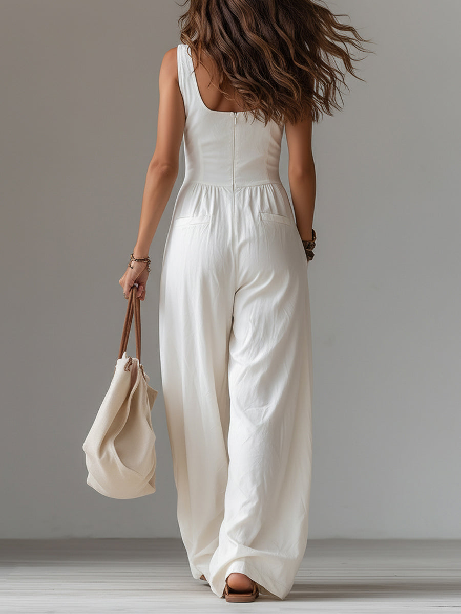 White sleeveless wide-leg jumpsuit with patch pockets for women, by Christine Brewer, shown in a stylish, casual outfit.