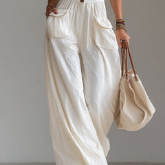 White sleeveless wide-leg jumpsuit with patch pockets for women, by Christine Brewer, shown in a stylish, casual fit.