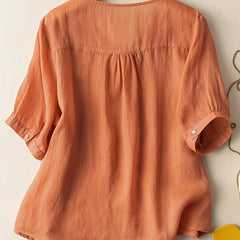 Light blue V-neck linen summer blouse for women, flowy and casual, by Christine Brewer, stylish top for warm weather.