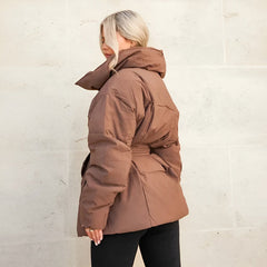 Alice belted puffer jacket for women by Christine Brewer, shown in a stylish quilted design with a belt and high collar.