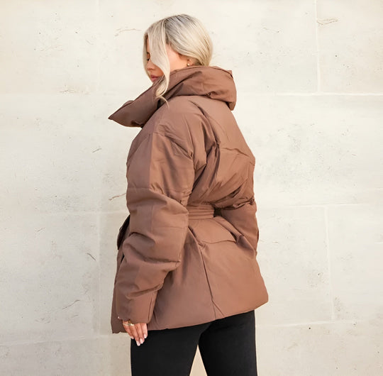 Alice belted puffer jacket for women by Christine Brewer, shown in a stylish quilted design with a belt and high collar.