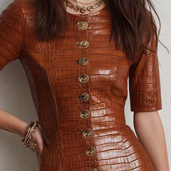 Caramel croc-embossed faux leather midi dress by Christine Brewer, shown with a sleek silhouette and textured finish.