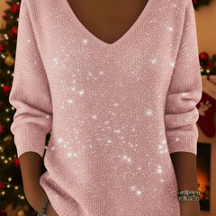 Christine Brewer Penelope soft knit Christmas sweater in elegant red with festive holiday patterns on a model.