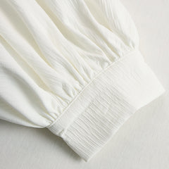 Cream textured lantern sleeve two-piece set for women with pants by Christine Brewer, featuring elegant, flowing fabric and lantern sleeves.