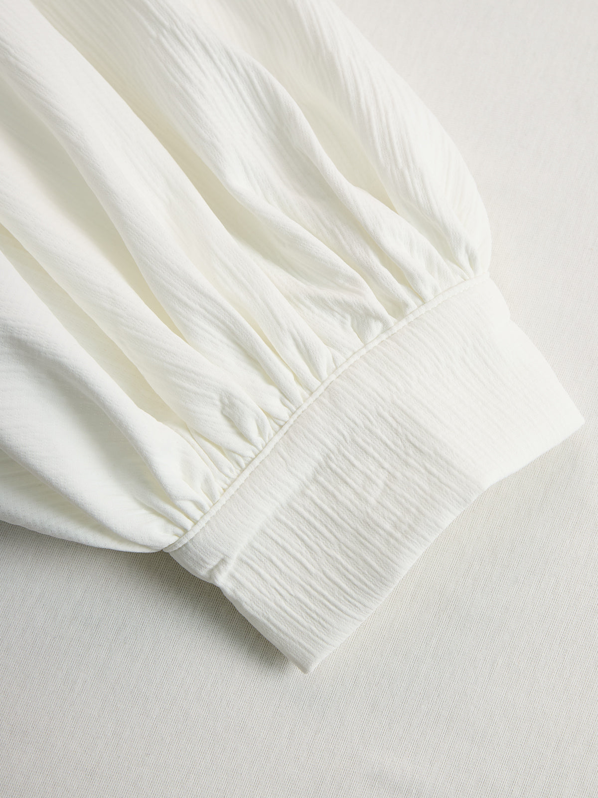Cream textured lantern sleeve two-piece set for women with pants by Christine Brewer, featuring elegant, flowing fabric and lantern sleeves.