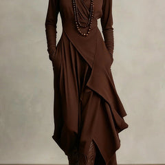 Solid color high-neck long-sleeved irregular casual maxi dress by Christine Brewer, shown hanging on a plain background.