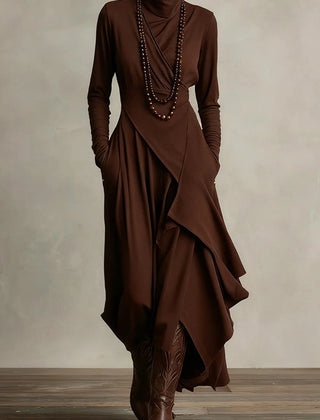 Solid color high-neck long-sleeved irregular casual maxi dress by Christine Brewer, shown hanging on a plain background.