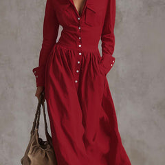 Christine Brewer high waisted maxi dress with long sleeves, buttoned front, pleated pockets, split-joint lapel in solid color.