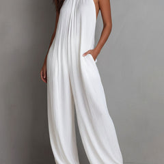 White pleated halter neck resort jumpsuit for women with wide-leg pants by Christine Brewer, featuring a stylish and comfortable design.