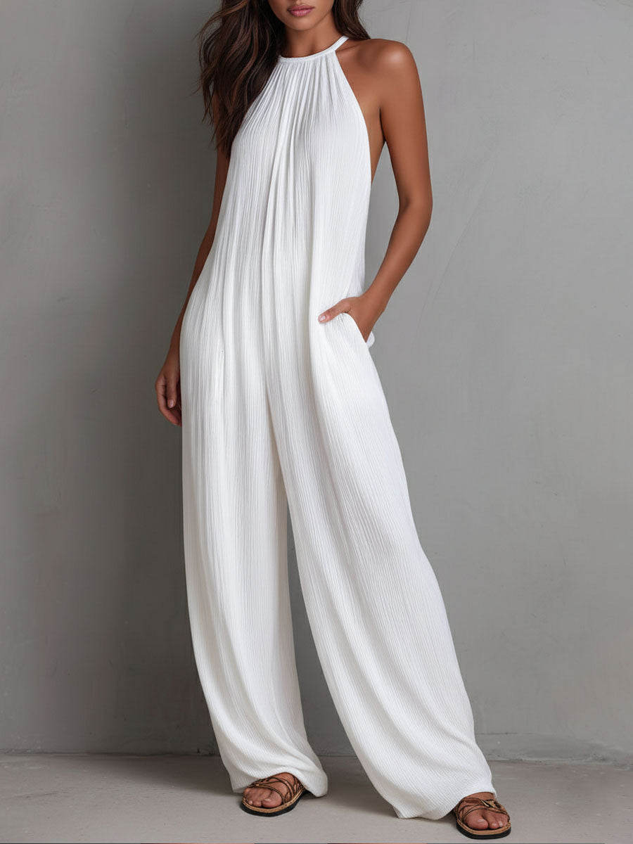 White pleated halter neck resort jumpsuit for women with wide-leg pants by Christine Brewer, featuring a stylish and comfortable design.