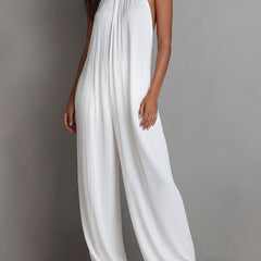 White pleated halter neck wide-leg resort jumpsuit for women by Christine Brewer, shown with flowing fabric and stylish design.
