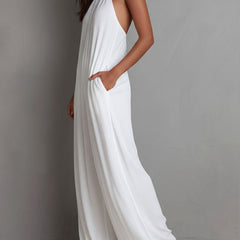 White pleated halter neck wide-leg resort jumpsuit for women by Christine Brewer, featuring flowing fabric and stylish design.