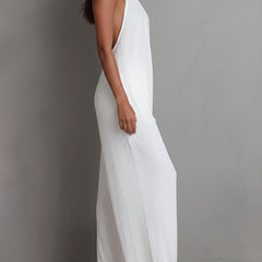 White pleated halter neck wide-leg resort jumpsuit for women by Christine Brewer, featuring flowing fabric and stylish design.