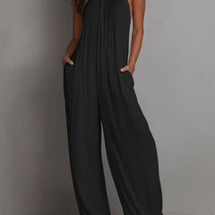 White pleated halter neck wide-leg resort jumpsuit for women, featuring stylish wide-leg pants from Christine Brewer.
