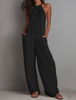 White pleated halter neck wide-leg resort jumpsuit for women, featuring stylish wide-leg pants from Christine Brewer.
