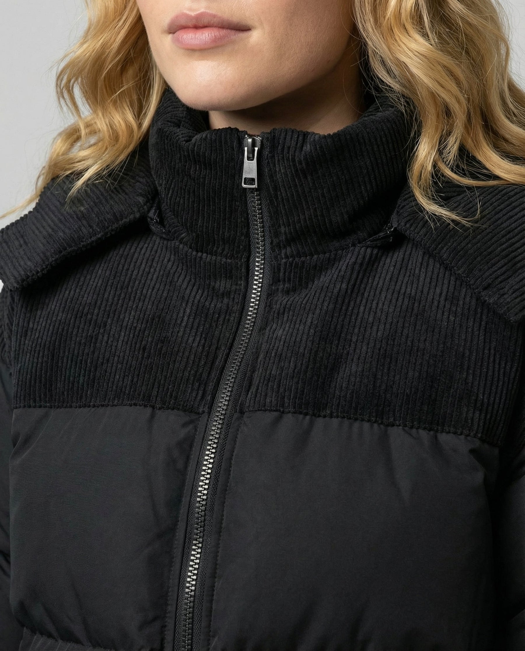 Close-up of the Cora Cosy Puffer Jacket for Women by Christine Brewer, showing textured fabric and detailed stitching.