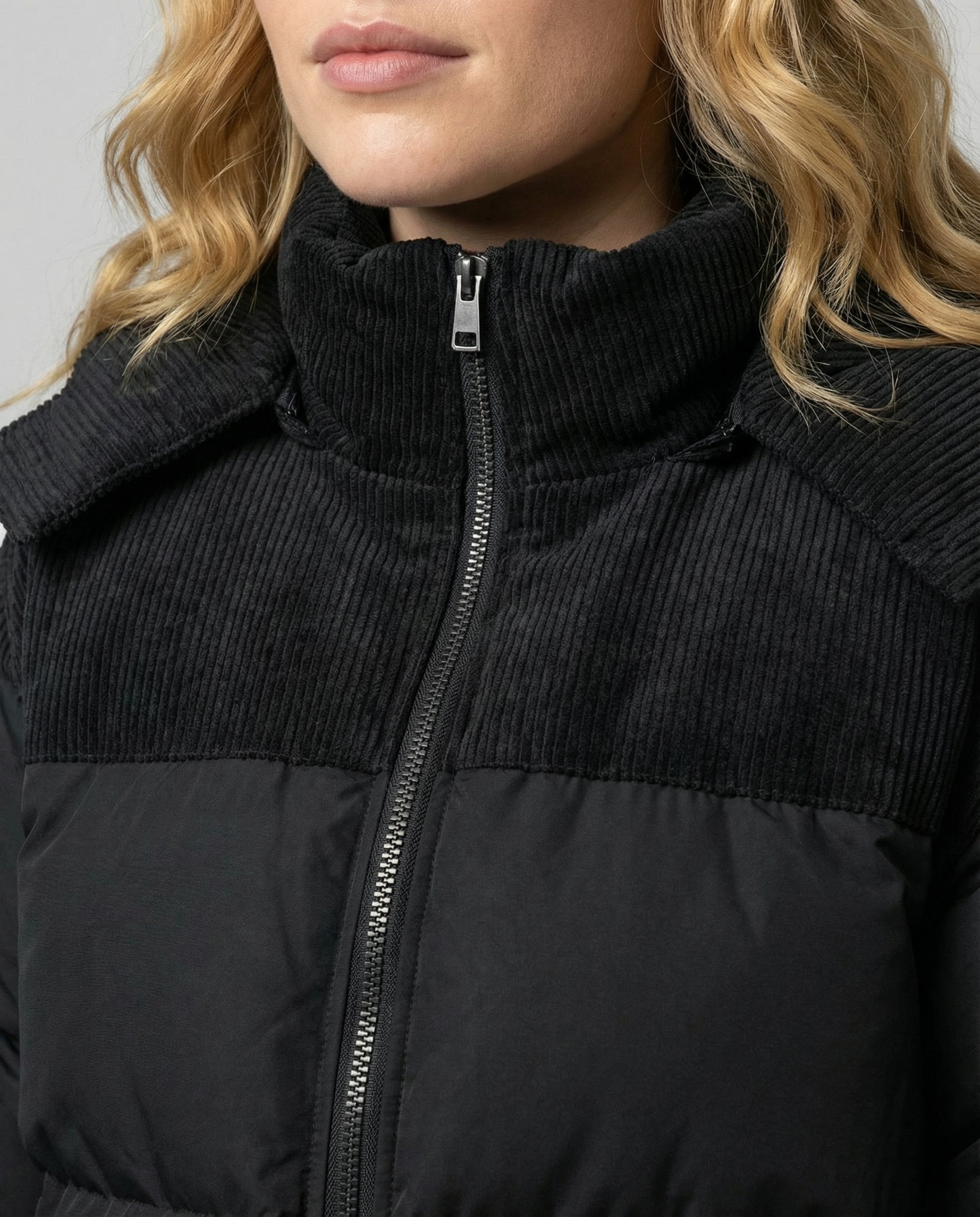 Close-up of the Cora Cosy Puffer Jacket for Women by Christine Brewer, showing textured fabric and detailed stitching.