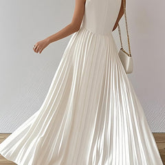 White A-line maxi dress by Christine Brewer featuring loose fit, pleats, and a V-neck, perfect for elegant casual wear.