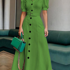 White maxi dress with puff short sleeves, belted waist, button details, and lapel collar by Christine Brewer.