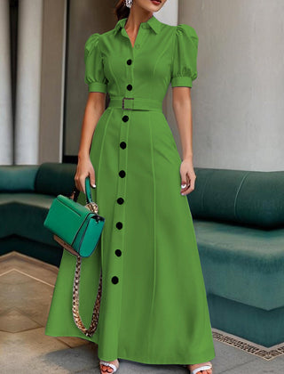 White maxi dress with puff short sleeves, belted waist, button details, and lapel collar by Christine Brewer.