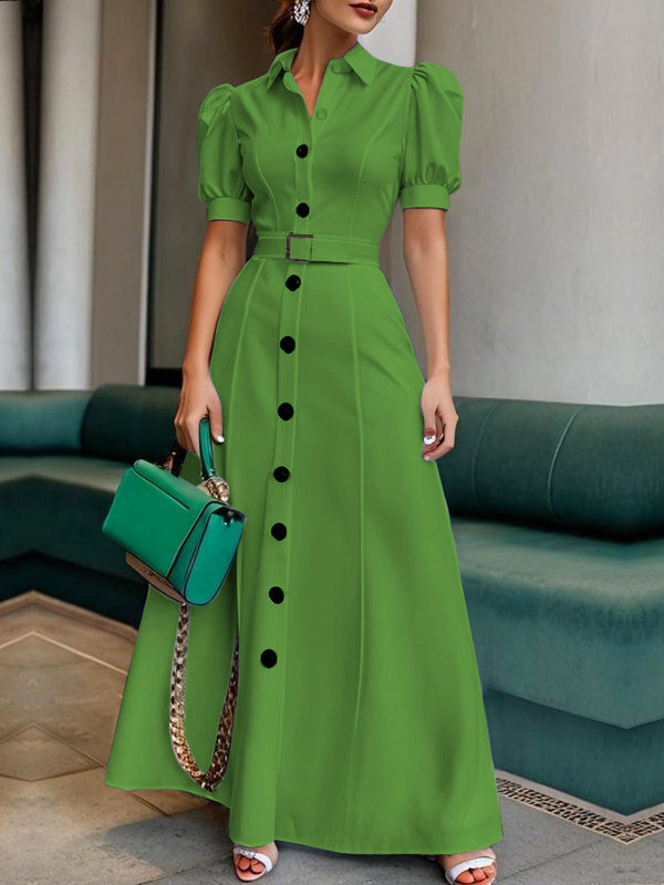 White maxi dress with puff short sleeves, belted waist, button details, and lapel collar by Christine Brewer.