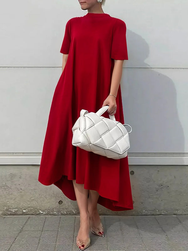 White high-low maxi dress with short sleeves by Christine Brewer, featuring a solid color design and flowing silhouette.