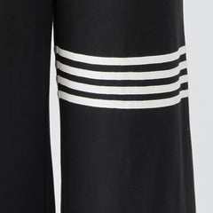 Black striped sleeveless hooded jumpsuit for women, stylish pants by Christine Brewer, shown on a model in a casual setting.