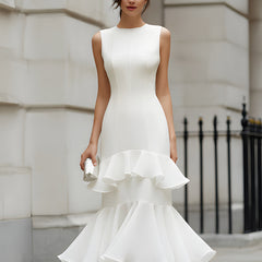Christine Brewer sleeveless tiered ruffle midi dress hanging on a wooden hanger, showcasing its flowy, layered design and ruffle details.