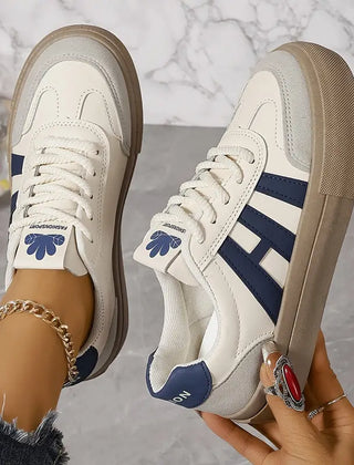 Elegant women's striped flowy sneakers by Christine Brewer with stylish design and comfortable fit.