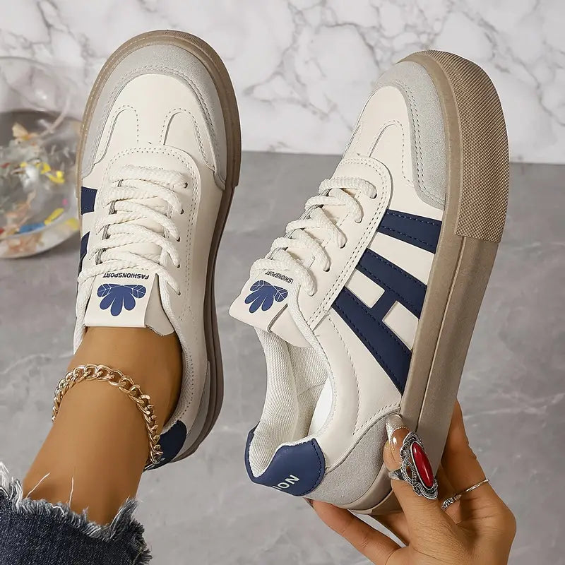 Elegant women's striped flowy sneakers by Christine Brewer with stylish design and comfortable fit.