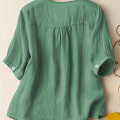 Women’s summer blouse by Christine Brewer featuring a V-neck, linen fabric, and a flowy, casual fit.