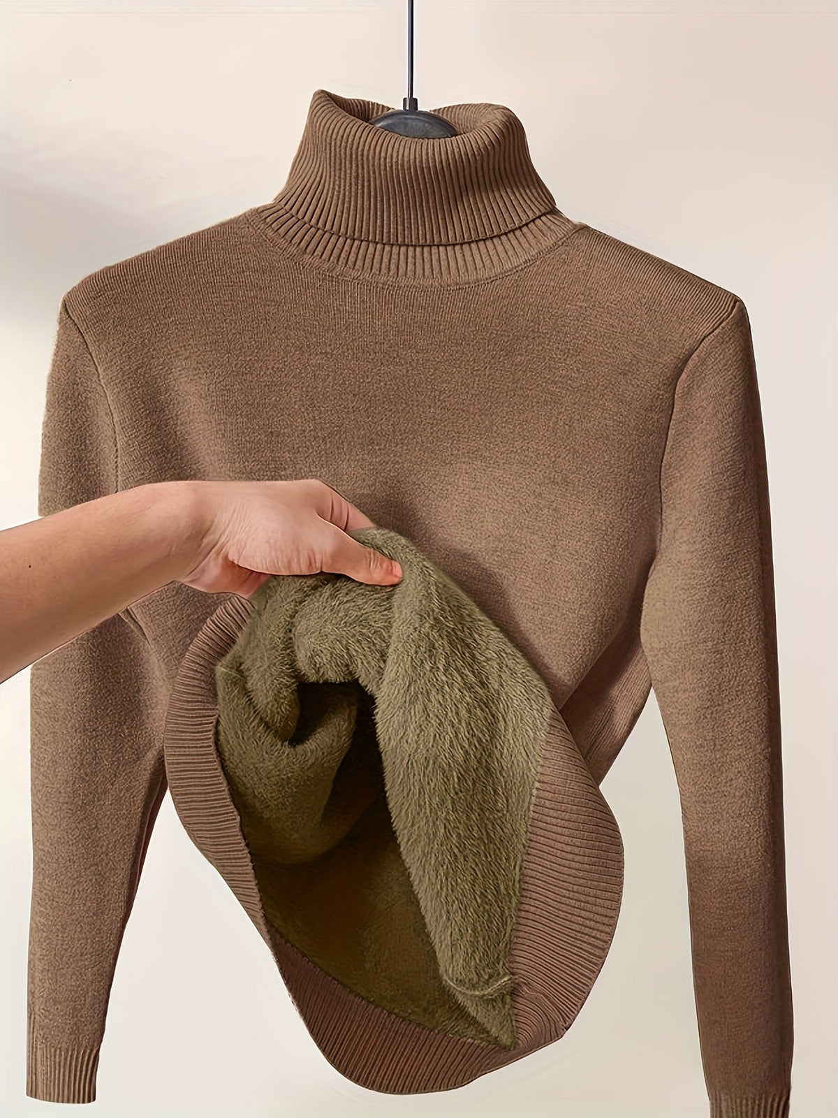 Women’s Peyton turtleneck sweater by Christine Brewer in cozy knit, shown in a neutral color with a close-up of the fabric texture.