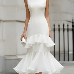 Sleeveless tiered ruffle midi dress by Christine Brewer displayed on a mannequin, featuring flowy fabric and layered ruffle details.