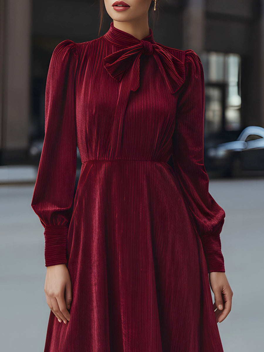 Burgundy velvet pleated midi dress with bow-neck detail by Christine Brewer, perfect for cocktail occasions.