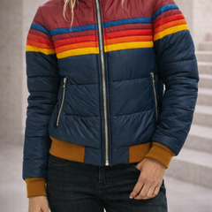 Christine Brewer Clara hooded quilted puffer jacket for women, featuring a padded design and a hood, displayed on a hanger.