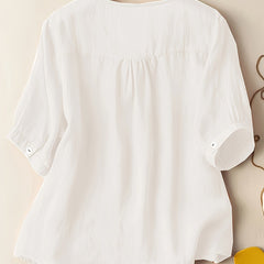 Light beige women's summer blouse by Christine Brewer featuring a V-neck, linen fabric, and a flowy, casual design.