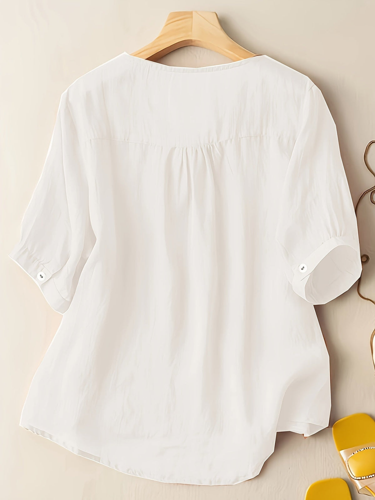 Light beige women's summer blouse by Christine Brewer featuring a V-neck, linen fabric, and a flowy, casual design.