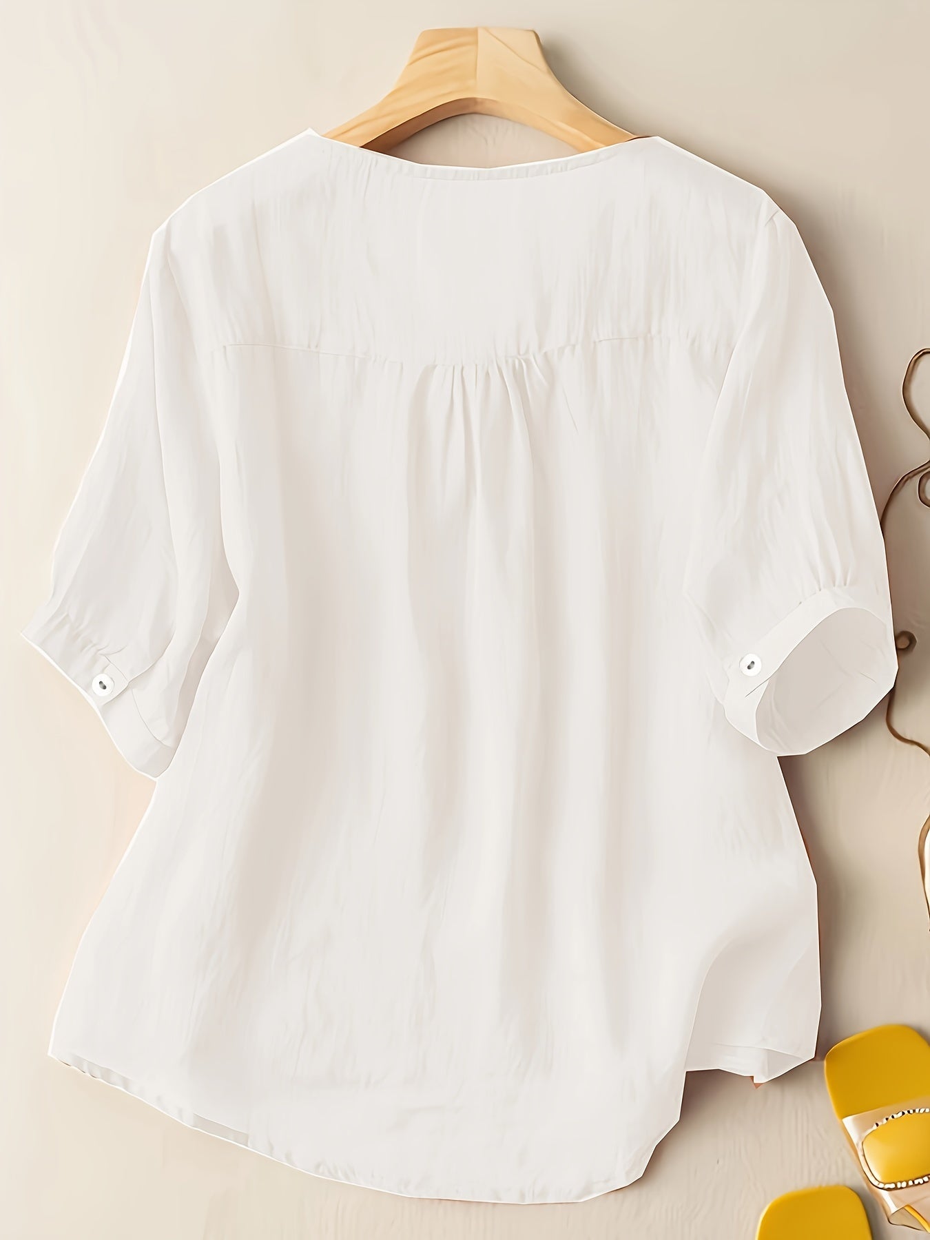 Light beige women's summer blouse by Christine Brewer featuring a V-neck, linen fabric, and a flowy, casual design.