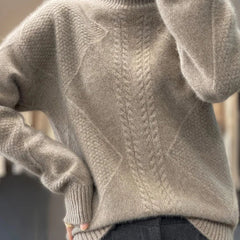 Christine Brewer Selena cable knit turtleneck sweater for women, showing the cozy, textured knit pattern and high turtleneck design.