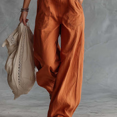 Rust orange cotton Western V-neck sleeveless jumpsuit for women, featuring pants style and a relaxed fit by Christine Brewer.
