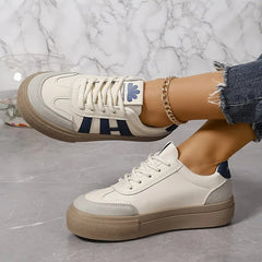 Elegant women's sneakers by Christine Brewer featuring striped design and flowy fabric for a stylish, comfortable look.
