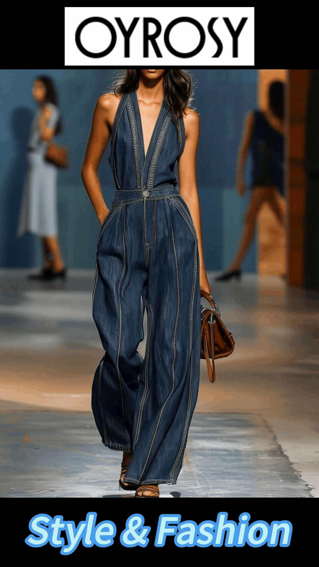 Dark blue denim sleeveless jumpsuit with V-neck and wide-leg pants, designed for women by Christine Brewer.