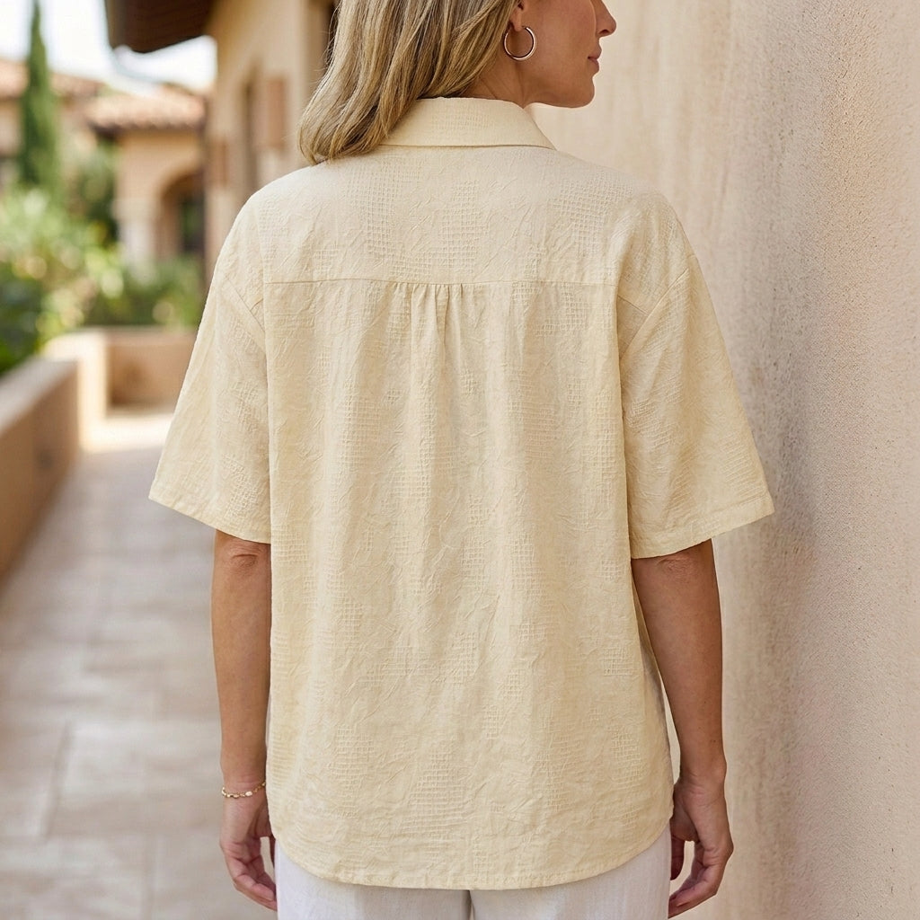 Back view of Christine Brewer women's floral short sleeve denim summer blouse with a relaxed fit and feminine floral print.