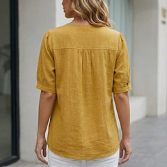 Back view of Christine Brewer summer women's linen blouse with short sleeves and front pockets.