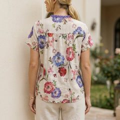 Back view of a floral summer blouse for women by Christine Brewer, short sleeve top with a relaxed fit.
