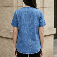 Back view of Christine Brewer women's summer denim top with button front, casual style, and classic denim fabric.