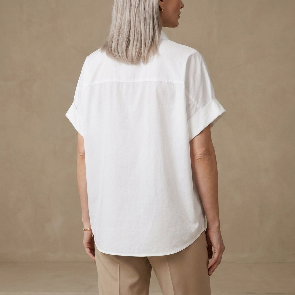 Back view of Christine Brewer women's summer denim blouse with short sleeves and wide-leg fit, showcasing casual stylish design.
